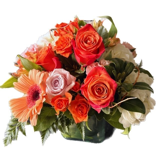 Bright mixed floral arrangement featuring orange roses, peach blooms, and gerbera daisies in a vase.